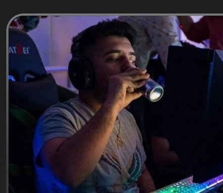 Harnit Khatri at his gaming setup — headset on, RGB keyboard glowing